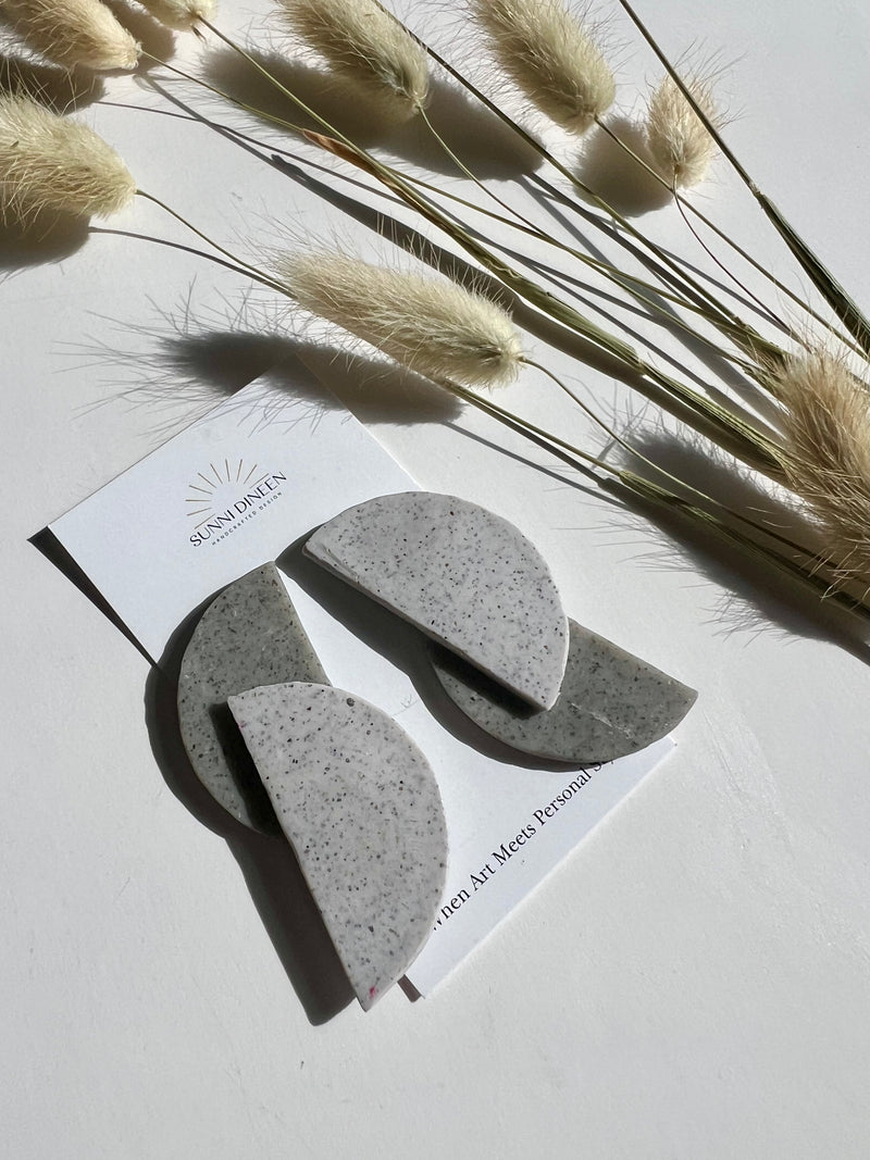 Elodi geometric statement earrings in cement on product card with Sunni Dineen Handcrafted Design logo — handcrafted jewelry for women.