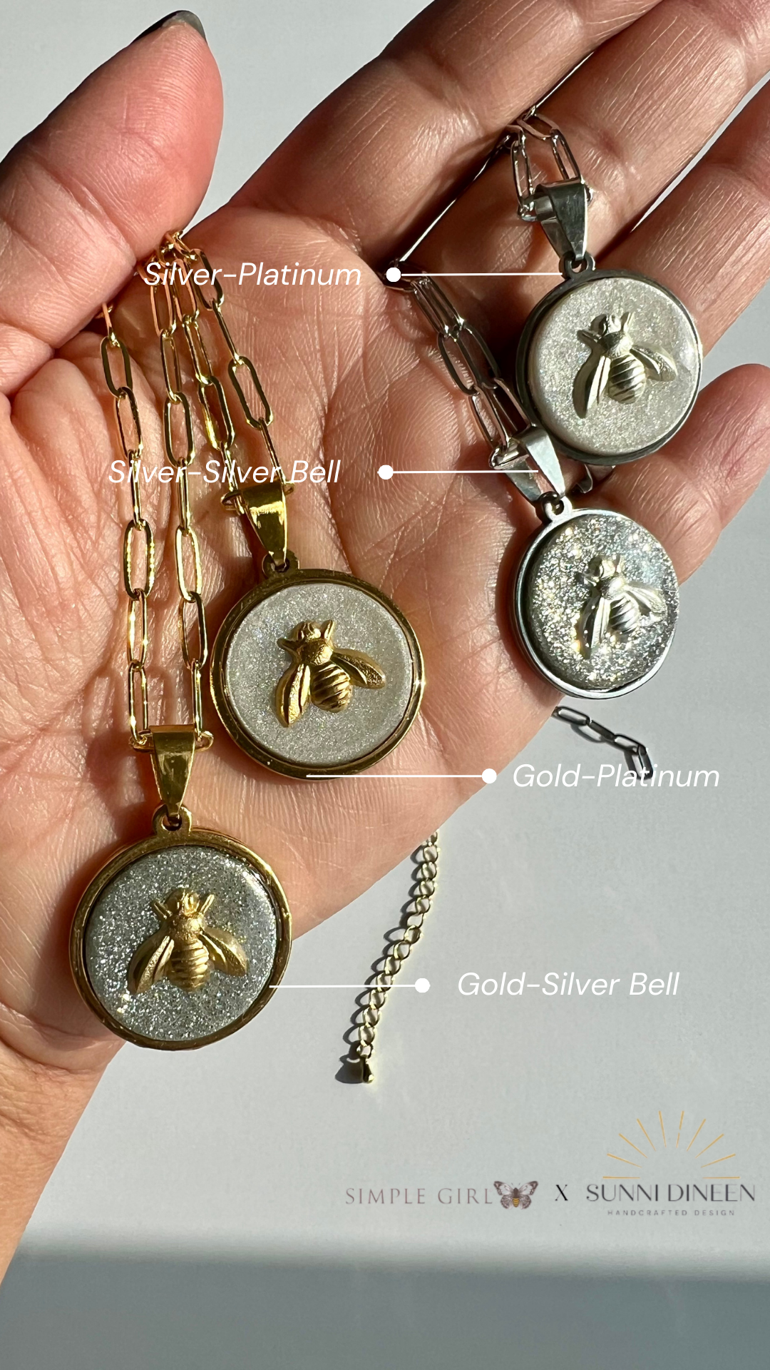 Hand holding four Queen Honeybee Pendant Necklaces with color variation labels from SGB X SDHD Collection.