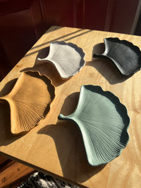 4 Ginkgo Leaf Trinket Dishes, handmade by Sunni Dineen, arranged on a wooden surface 