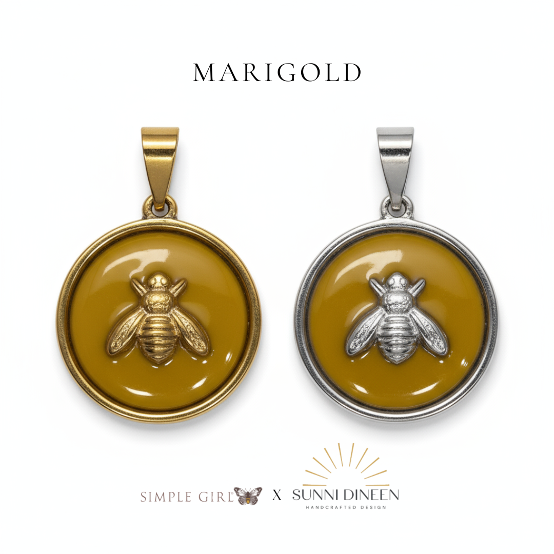 Queen Honeybee Necklace Pendants, one gold and one silver displayed on a white background with 'MARIGOLD' text color option above by Simple Girl Brand X Sunni Dineen Handcrafted Design.