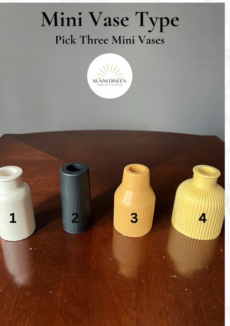 Four custom mini vase shape options in matte finishes displayed on a wooden table to choose from the custom mini vase styling kit by Sunni Dineen.