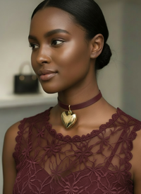 Woman wearing The Heart of Gold Choker Necklace by Sunni Dineen, in maroon-gold wearing a maroon lace blouse.