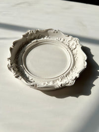 The ivory Resin Baroque Trinket Dish resting on a white surface, handmade by Sunni Dineen.