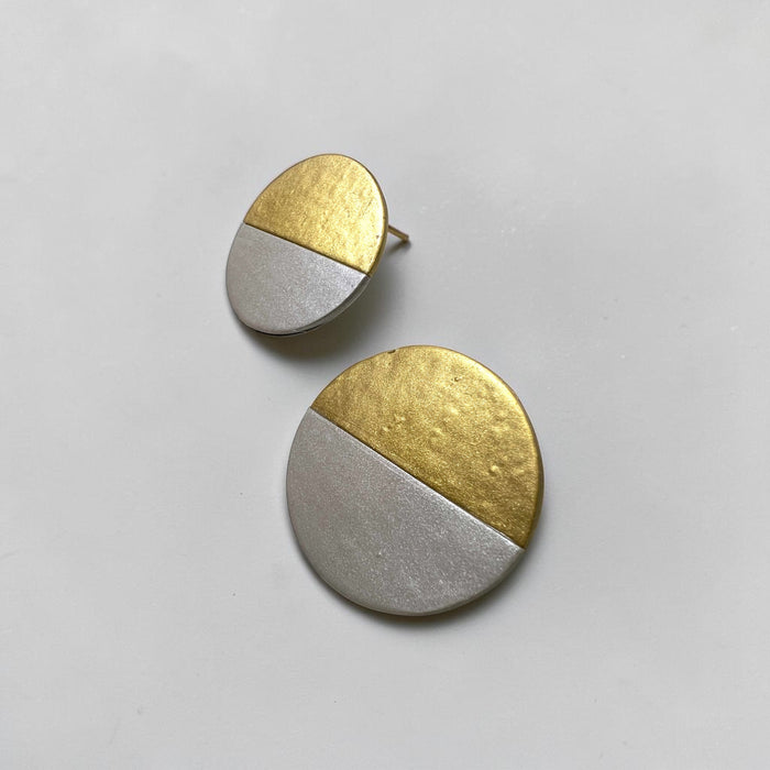 A pair of Lumi Statement Earrings displayed on a neutral surface; handmade by Sunni Dineen.
