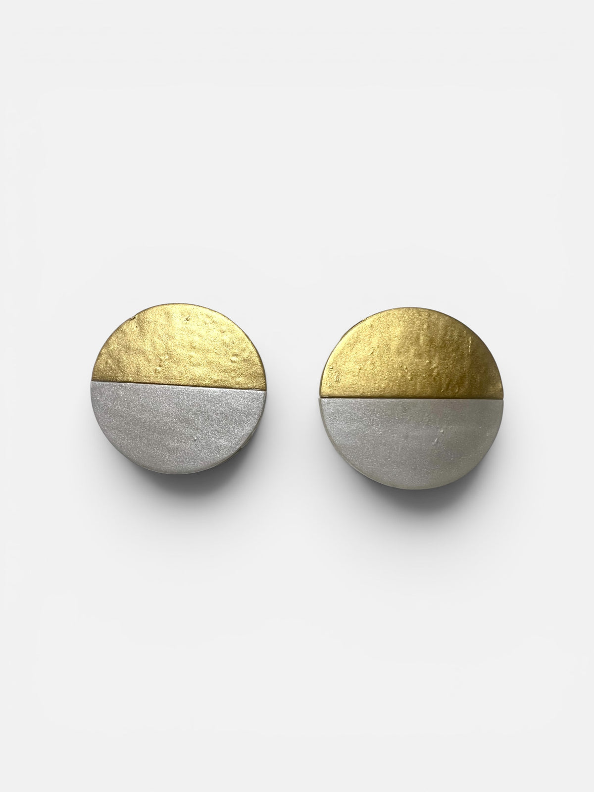 A pair of Lumi Statement Earrings displayed on a white surface; handmade by Sunni Dineen.