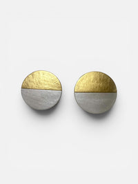 A pair of Lumi Statement Earrings displayed on a white surface; handmade by Sunni Dineen.