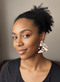 Model wearing oversized handmade statement earrings in brown created by Sunni Dineen Handcrafted Design—jewelry for women who wear their story.