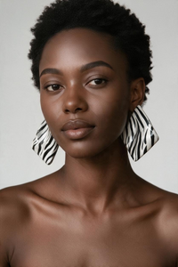 A woman styled wearing zebra "Monae" sculptural statement earrings 