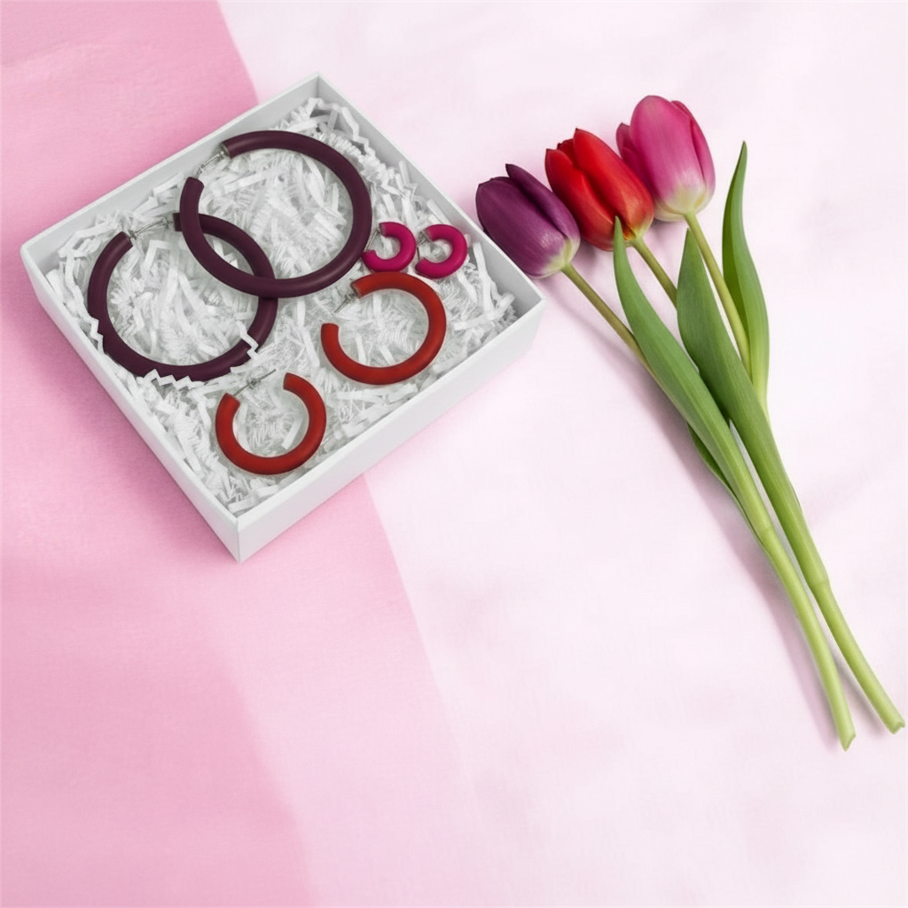 Mother's Day Gift Set featuring the "Classic Clay Hoop Earrings", buy two get a free pair, in a box with tulips on a pink background.