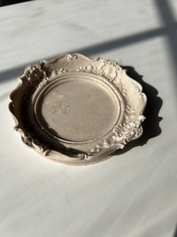 The natural colored Resin Baroque Trinket Dish resting on a white surface, handmade by Sunni Dineen.