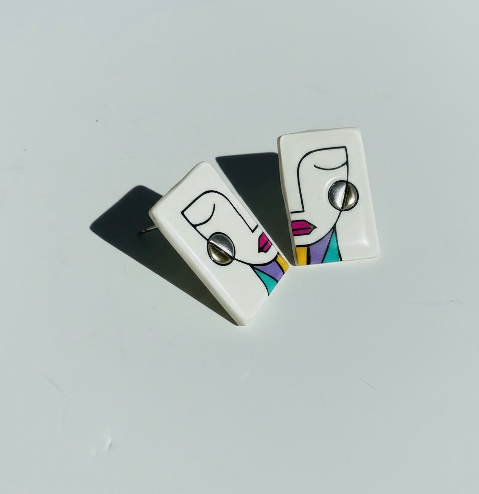 White-colored 'Simone' abstract face statement stud earrings handmade from polymer clay.