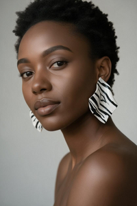 A woman styled wearing zebra "Monae" sculptural statement earrings 